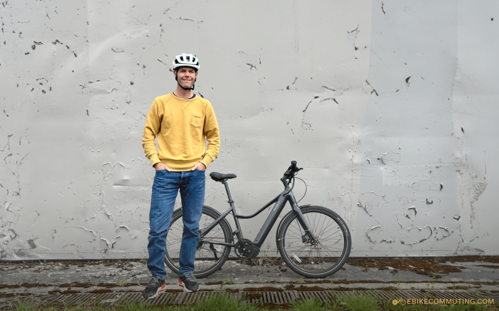 Tyler standing in front of a black Priority Current e-bike