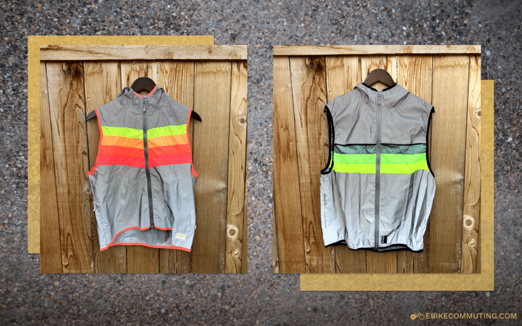 Two of GoFluo's reflective vests hanging in front of a fence.