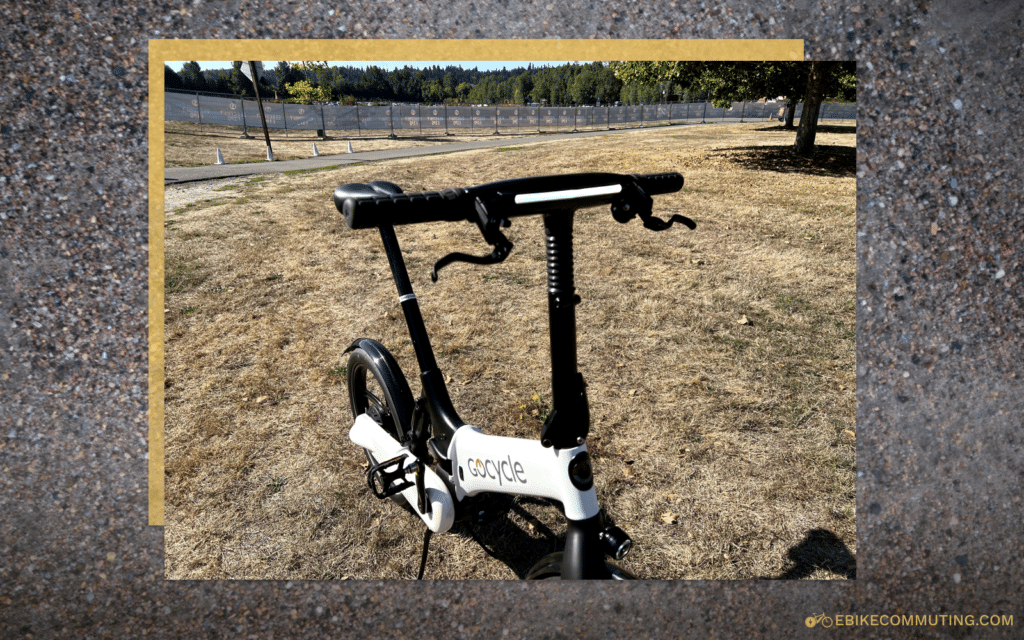 A while Gocycle G4i in a grass field with the running light on.